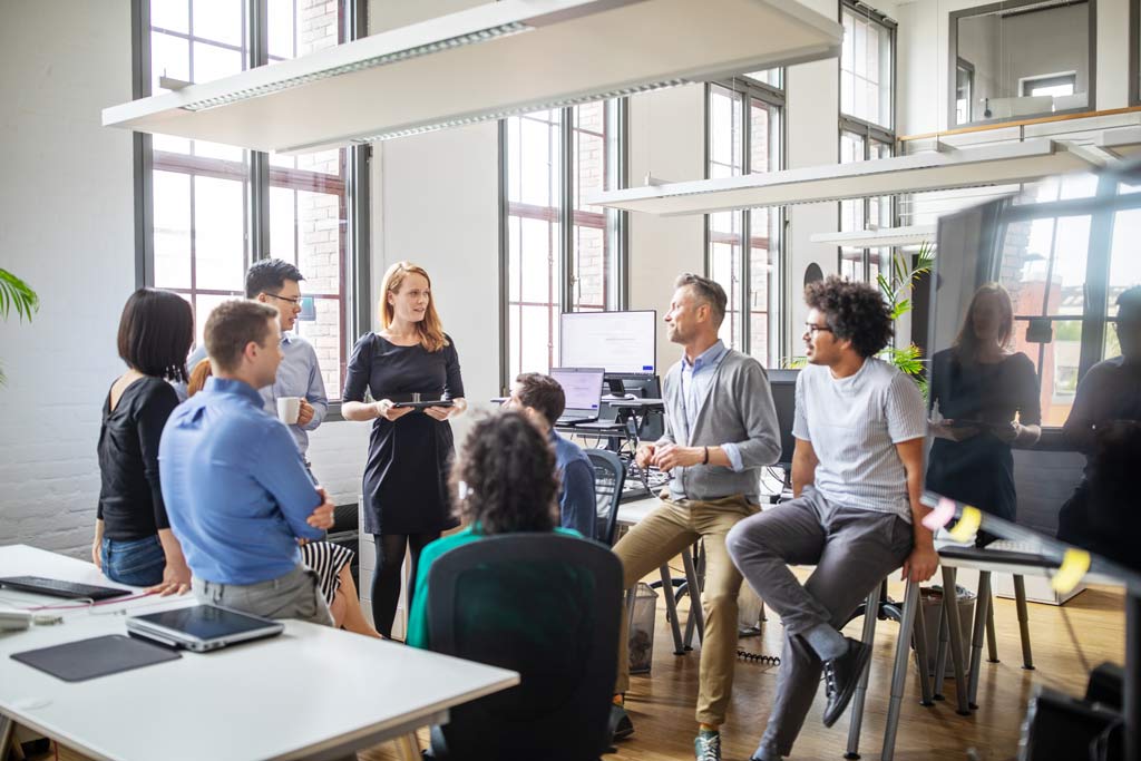 Team of Employees meeting casually in Office
